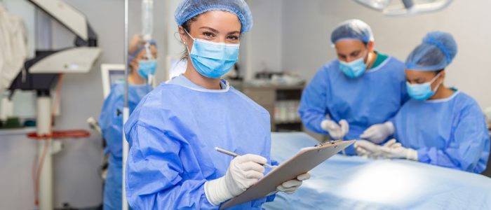 Surgeon writing on clipboard in operation room
